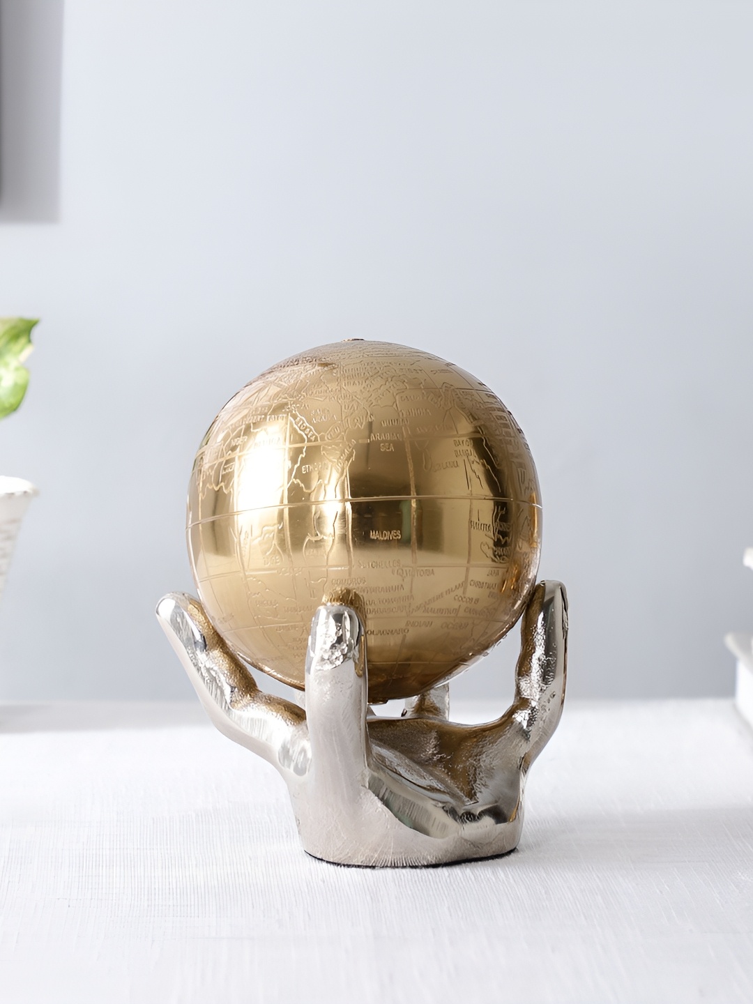 

Decor de Maison Silver-Toned & Gold Toned Hand With Globe Showpiece