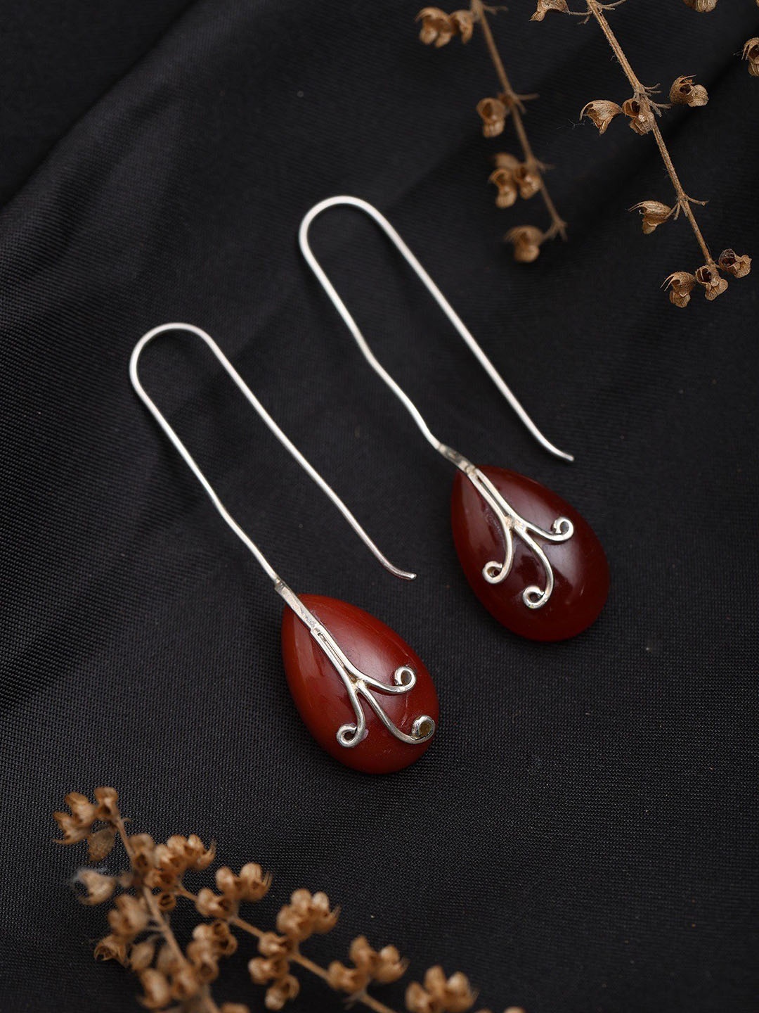 

Exotic India Sterling Silver Long Hook Earrings with Almond Shaped Ruby, Pink
