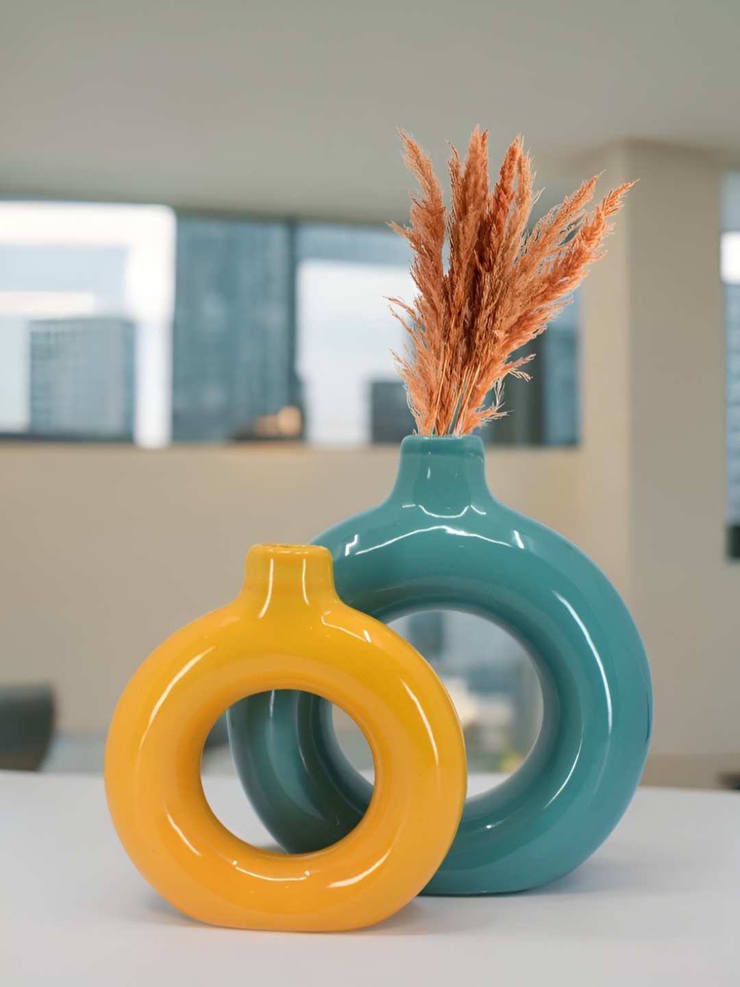 

The Decor Lane 2-Pcs Orange-Colored & Teal Blue Ceramic Donut Vase