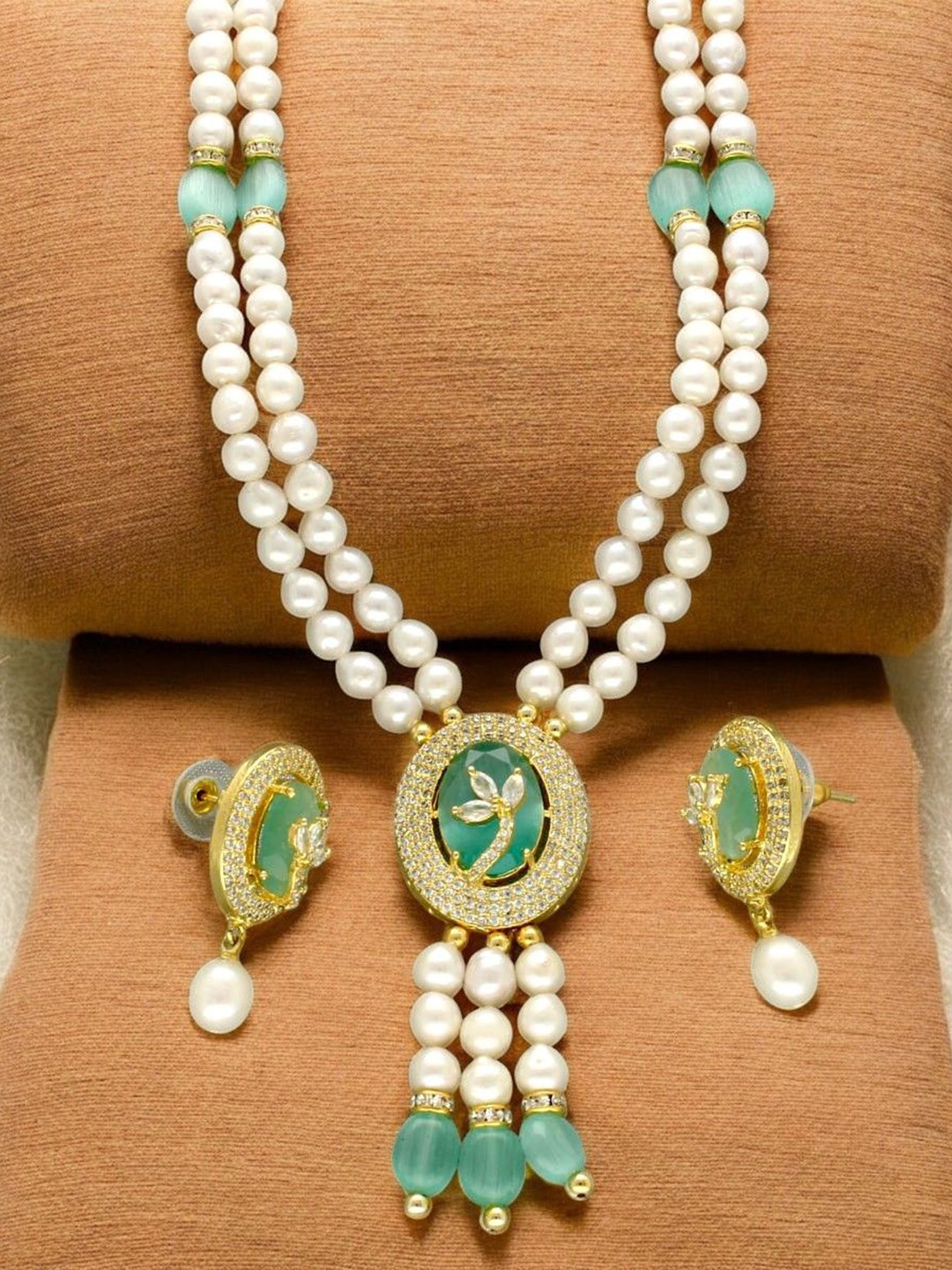 

Sri Jagdamba Pearls Dealer Gold Plated CZ Stone Studded & Beaded Jewellery Set