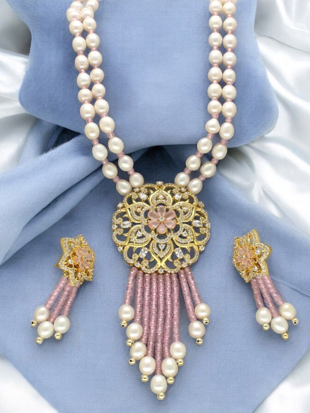 

Sri Jagdamba Pearls Dealer Gold Plated CZ Stone Studded & Beaded Jewellery Set