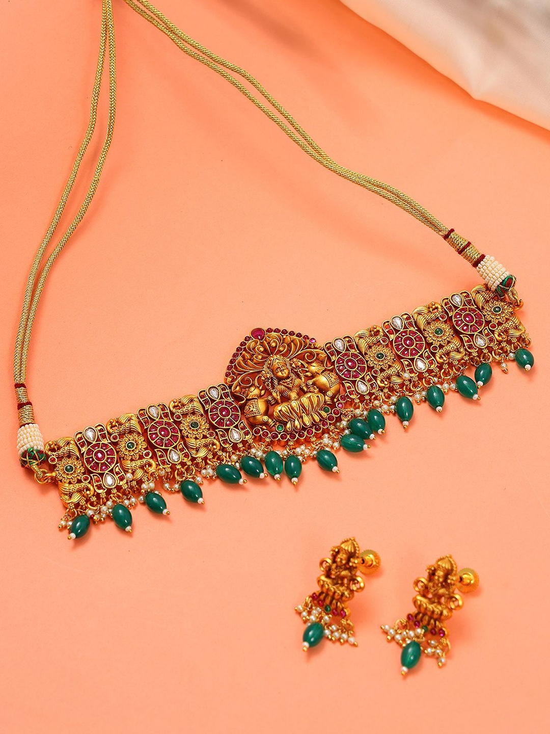 

Exotic India Goddess Gajalaxmi Studded & Beaded Choker with Earrings Jewellery Set, Gold