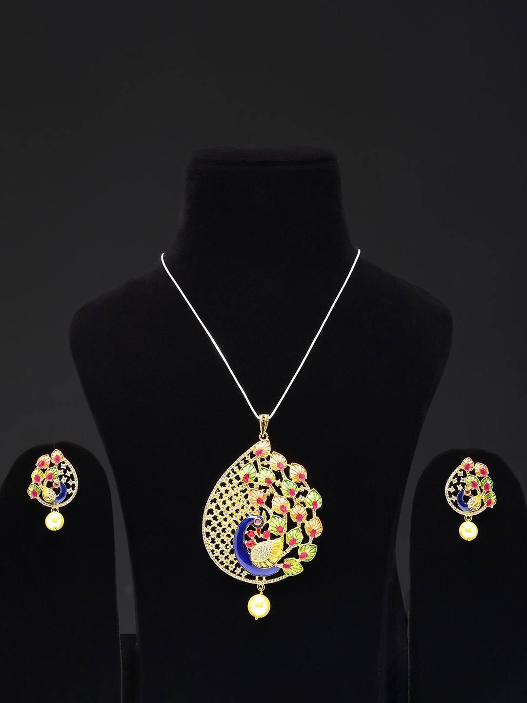 

Exotic India Designer Peacock Pendant and Earrings Set with Ruby and Cubic Zirconia, Gold