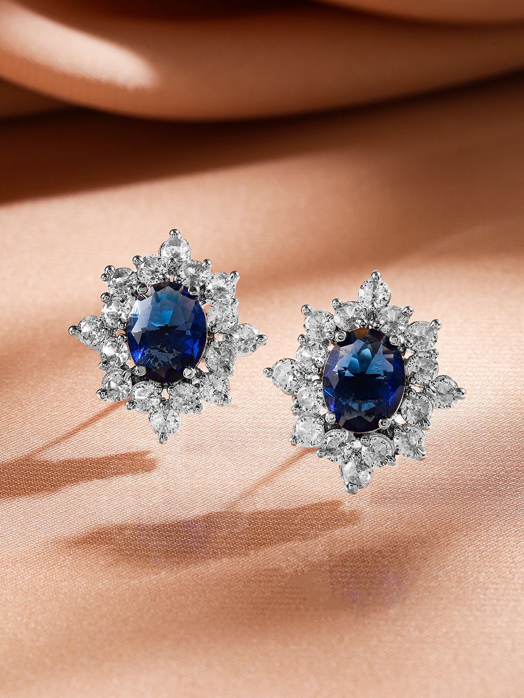 

Rubans Rhodium Plated Blue Sapphire & Cubic Zirconia Studded Floral Stud Earrings, Silver