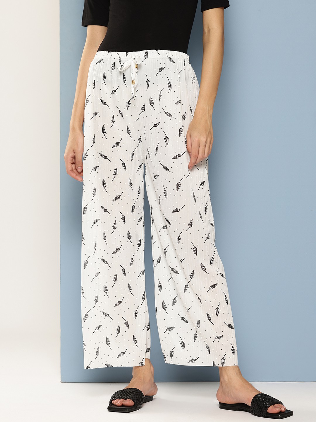 

Aarika Women Floral Printed Flared Palazzos, White