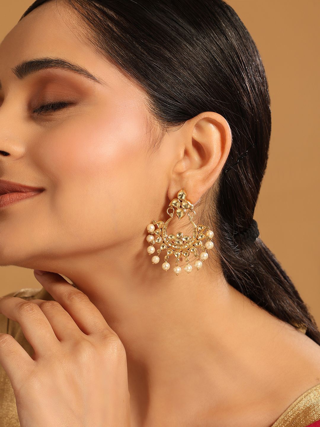 

Yinara 22K Gold Plated Kundan Studded Contemporary Shaped Chandbalis