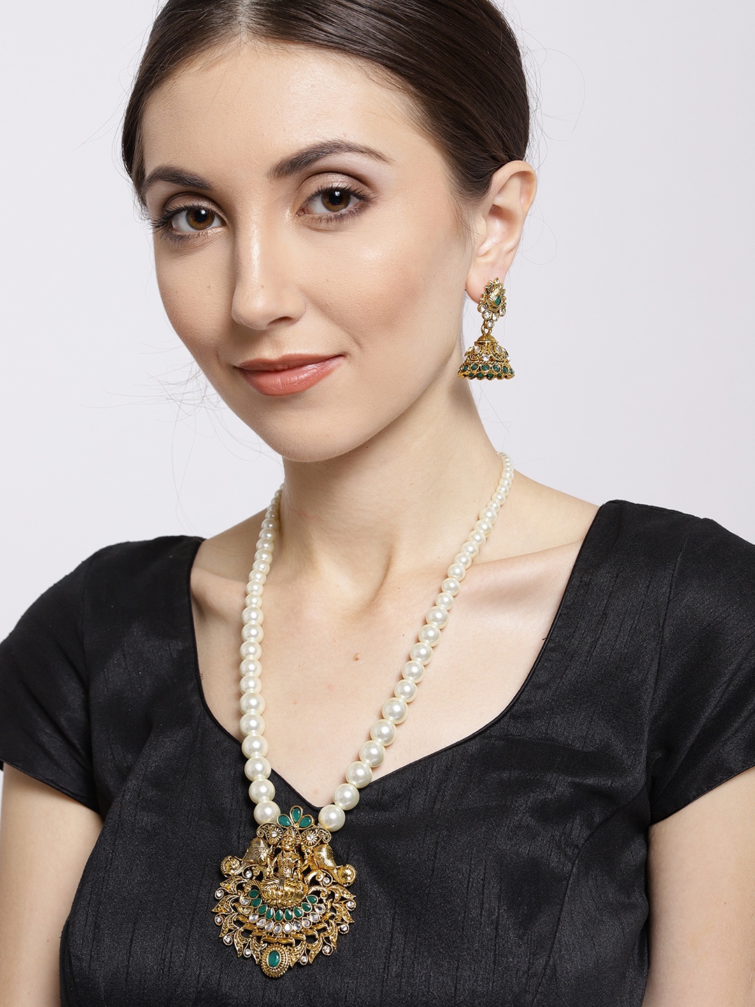 

Zaveri Pearls Antique Gold-Toned & Green Stone-Studded Goddess Temple Jewellery Set