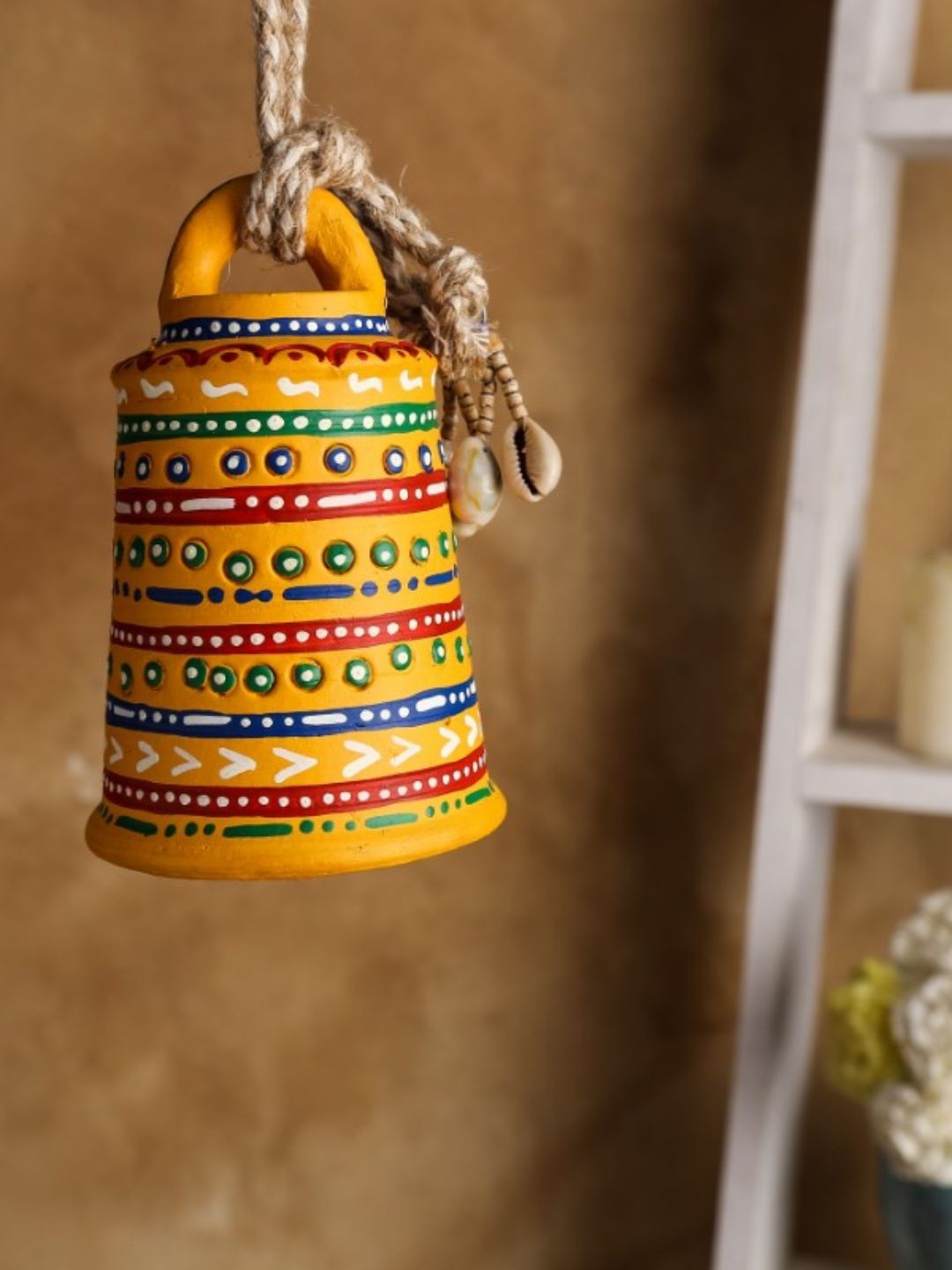 

Unravel India Warli Yellow Hand Painted Teracotta Hanging Bell