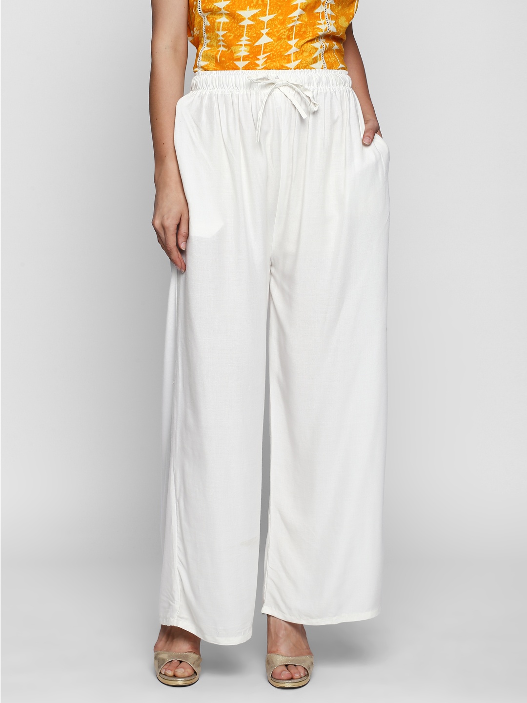 

Ishin Women White Solid Flared Palazzos