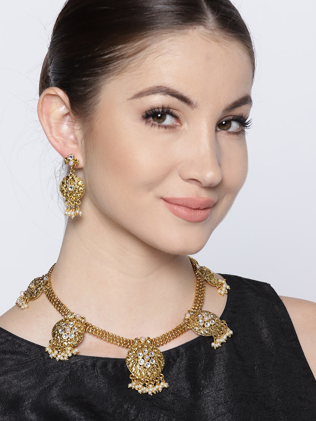 

Zaveri Pearls Gold-Toned & Off-White Stone-Studded Jewellery Set
