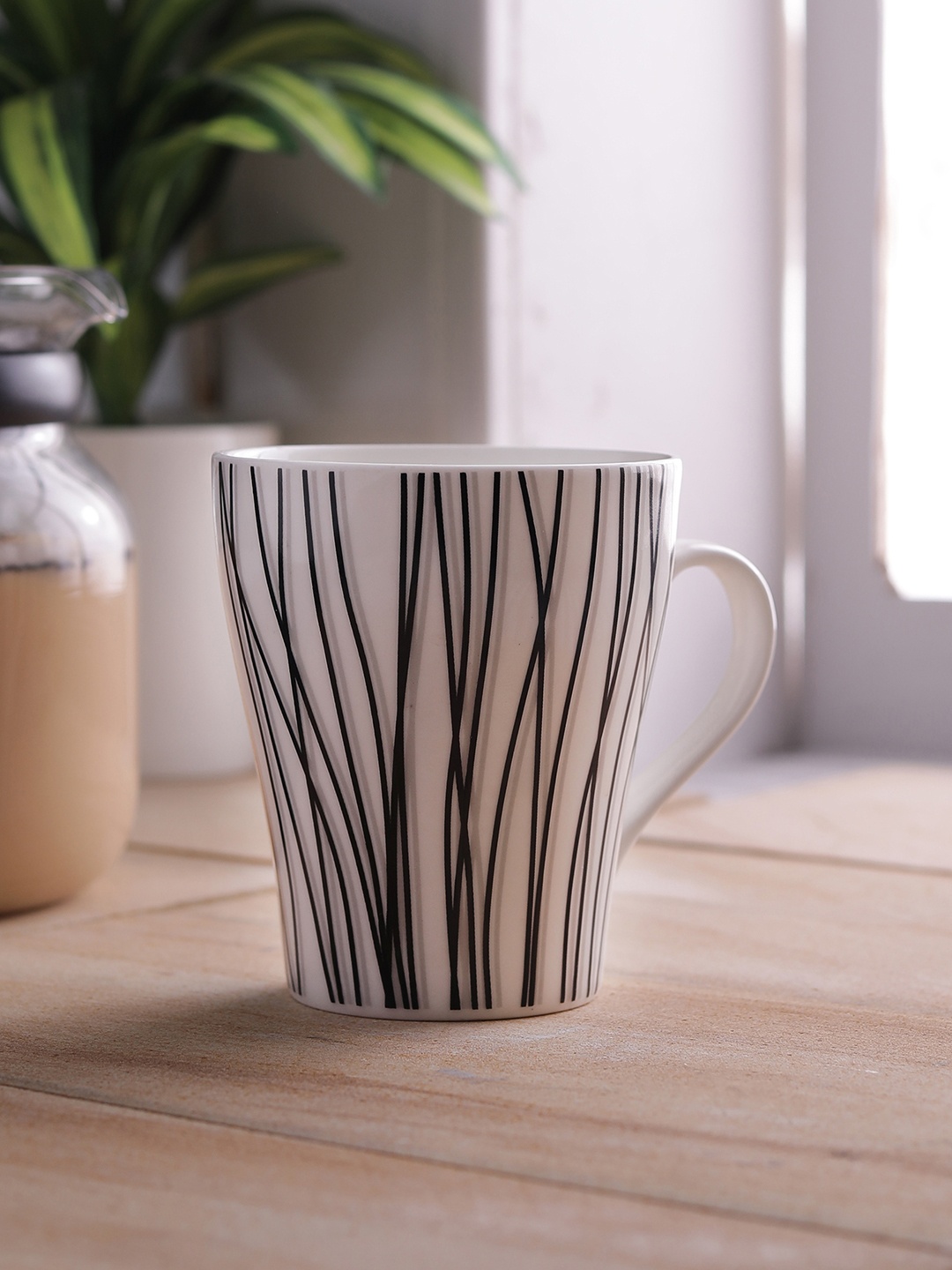 

CLAY CRAFT White & Black 4-Pieces Printed Bone China Cups Set