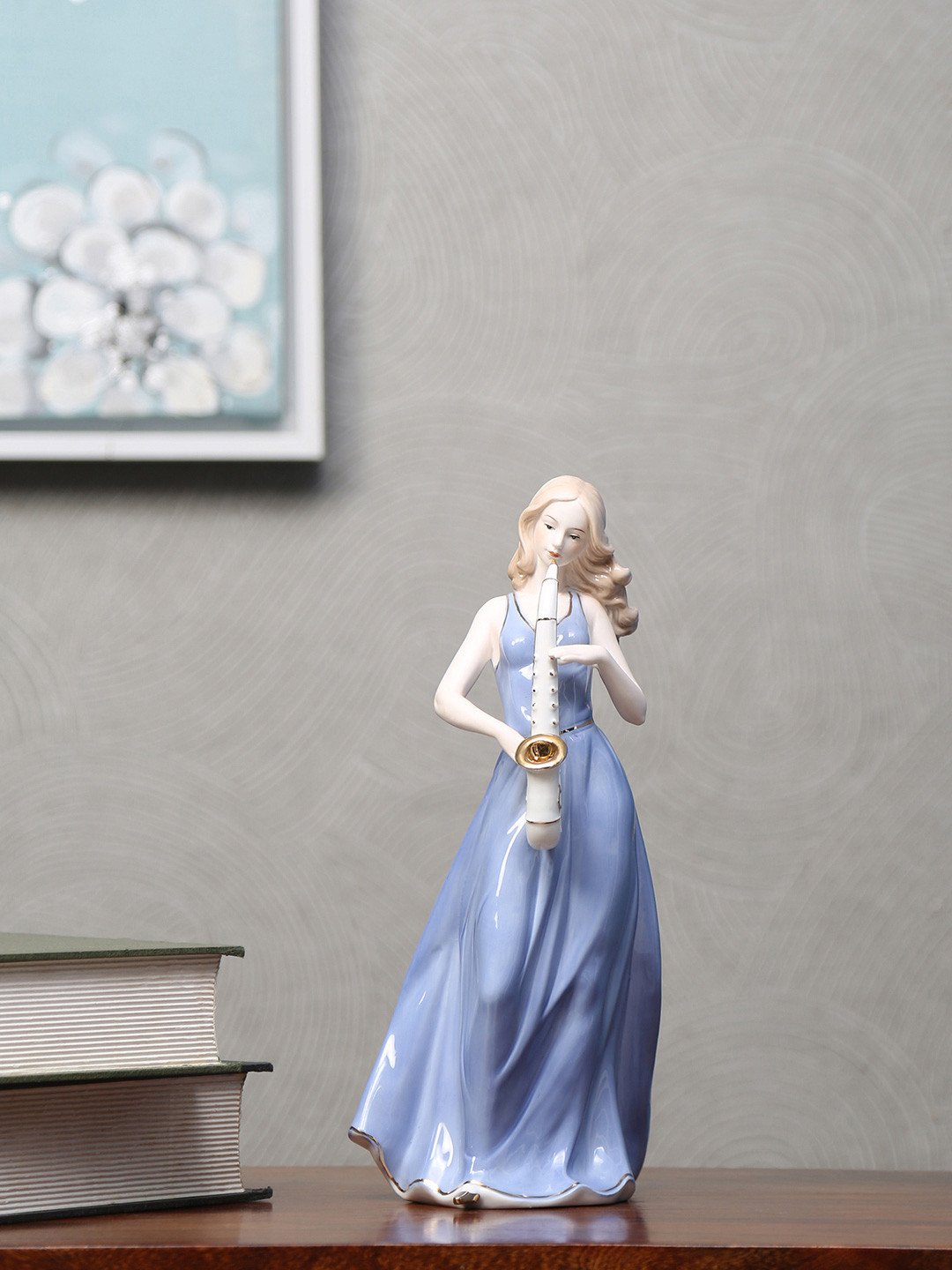 

Athome by Nilkamal Blue & White Lady Playing Trumpet Showpiece
