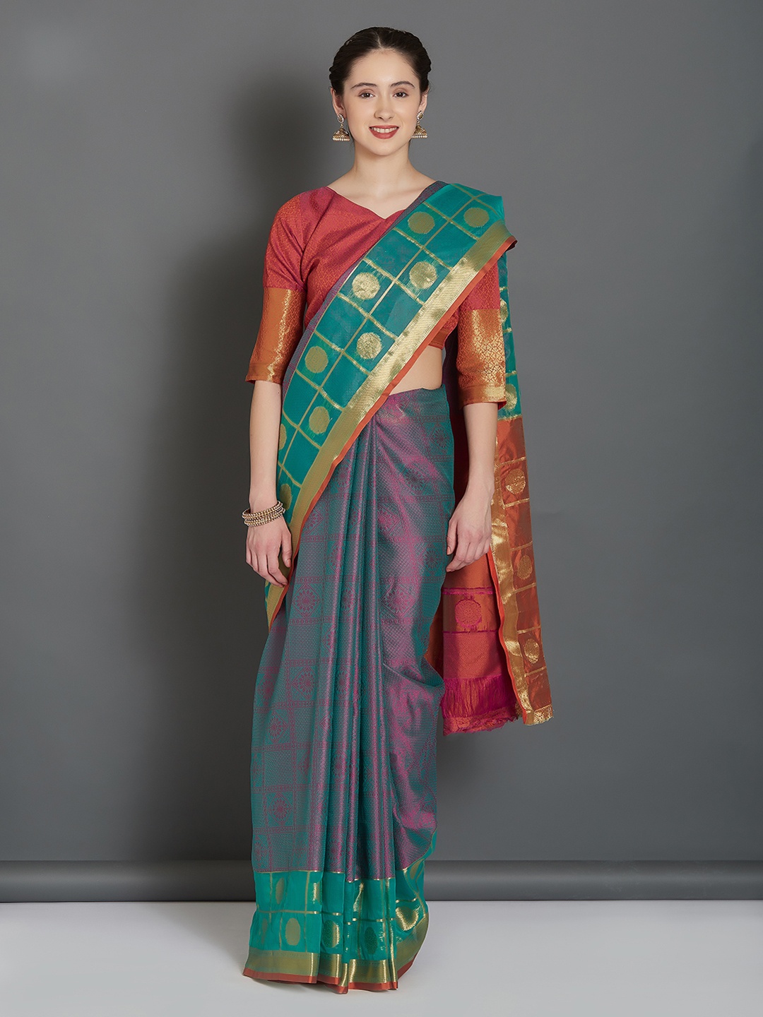 

Mitera Teal Green and Orange Silk Blend Woven Design Banarasi Saree