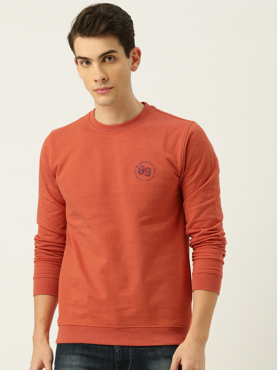 

Peter England Men Coral Pink Solid Sweatshirt