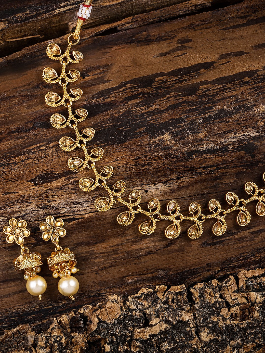 

Zaveri Pearls Gold Toned & Red Jewellery Set