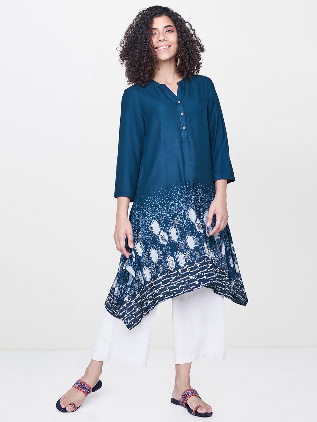 

Global Desi Women Teal Blue Printed A-Line Kurta with Asymmetric Hem