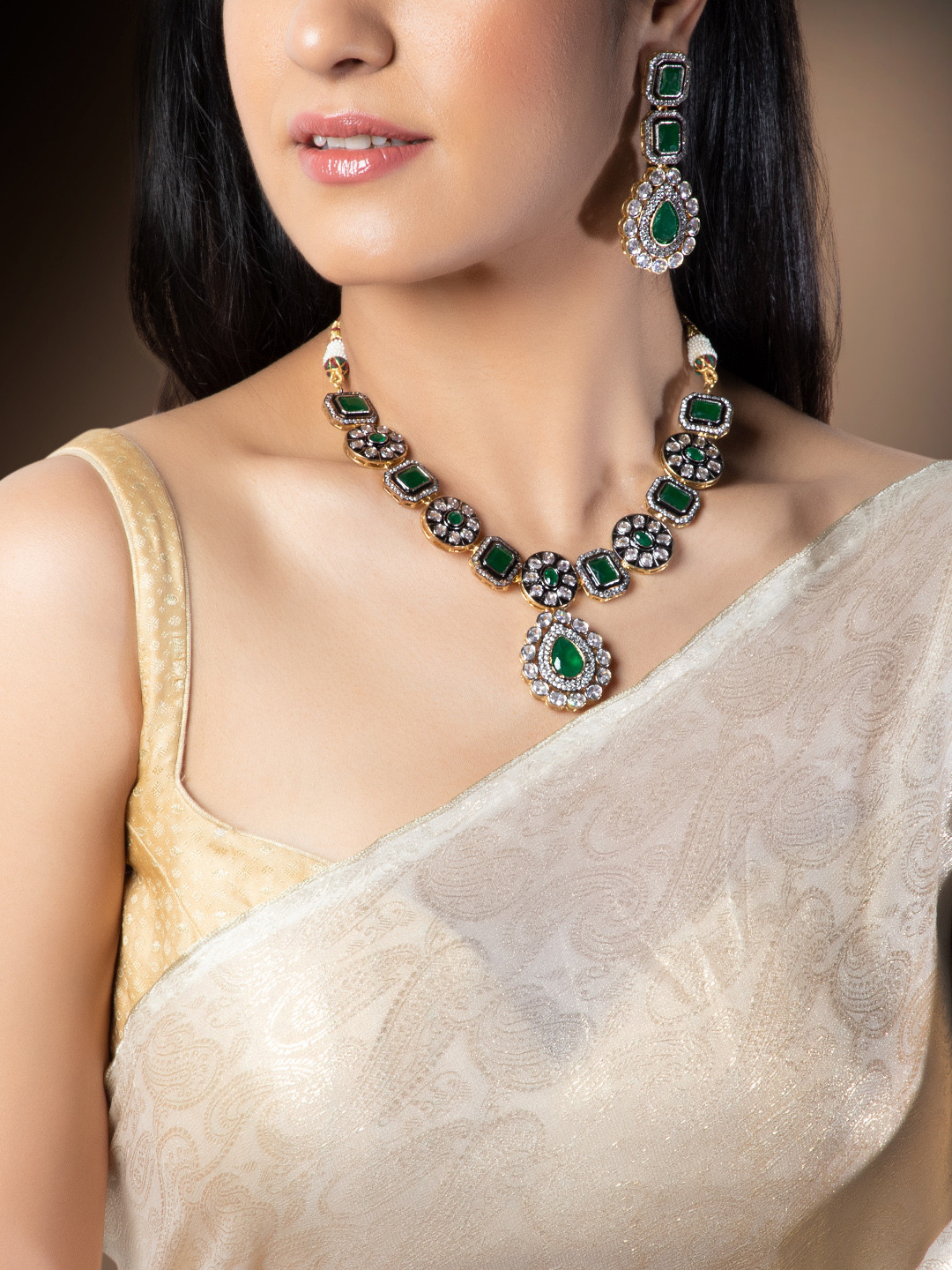 

Rubans Gold Plated Vintage CZ Studded Faux Emerald Embellished Statement Necklace Set