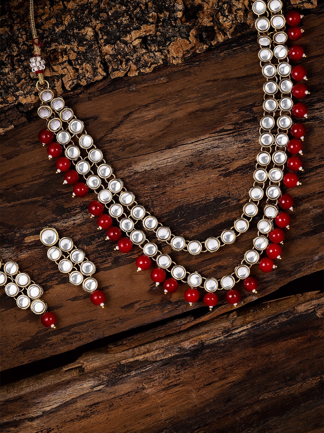 

Zaveri Pearls Gold-Toned & Red Kundan Jewellery Set