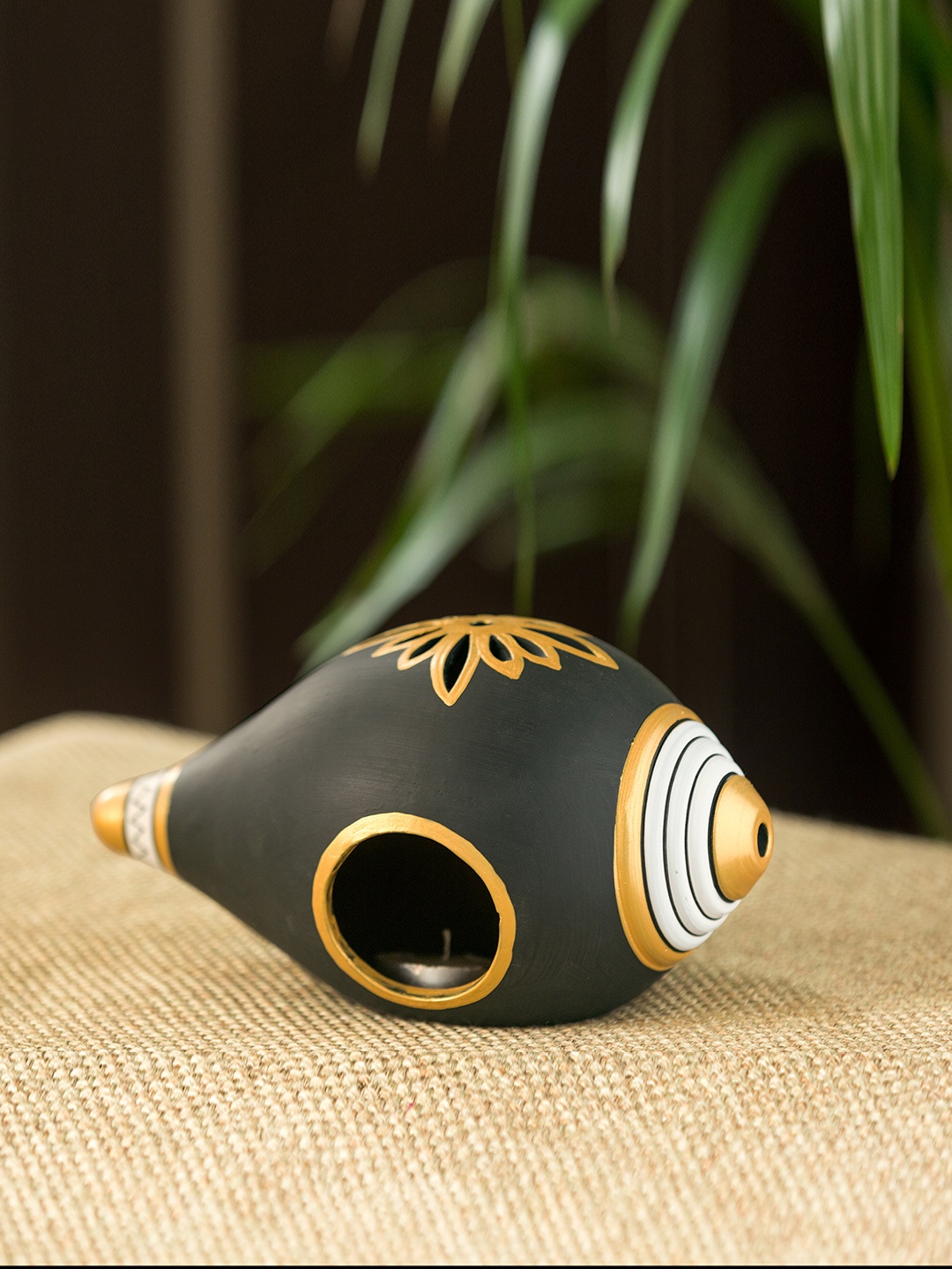 

ExclusiveLane Brown & Gold-Toned Shankh-Shaped Hand-Painted Terracotta Tea Light Holder