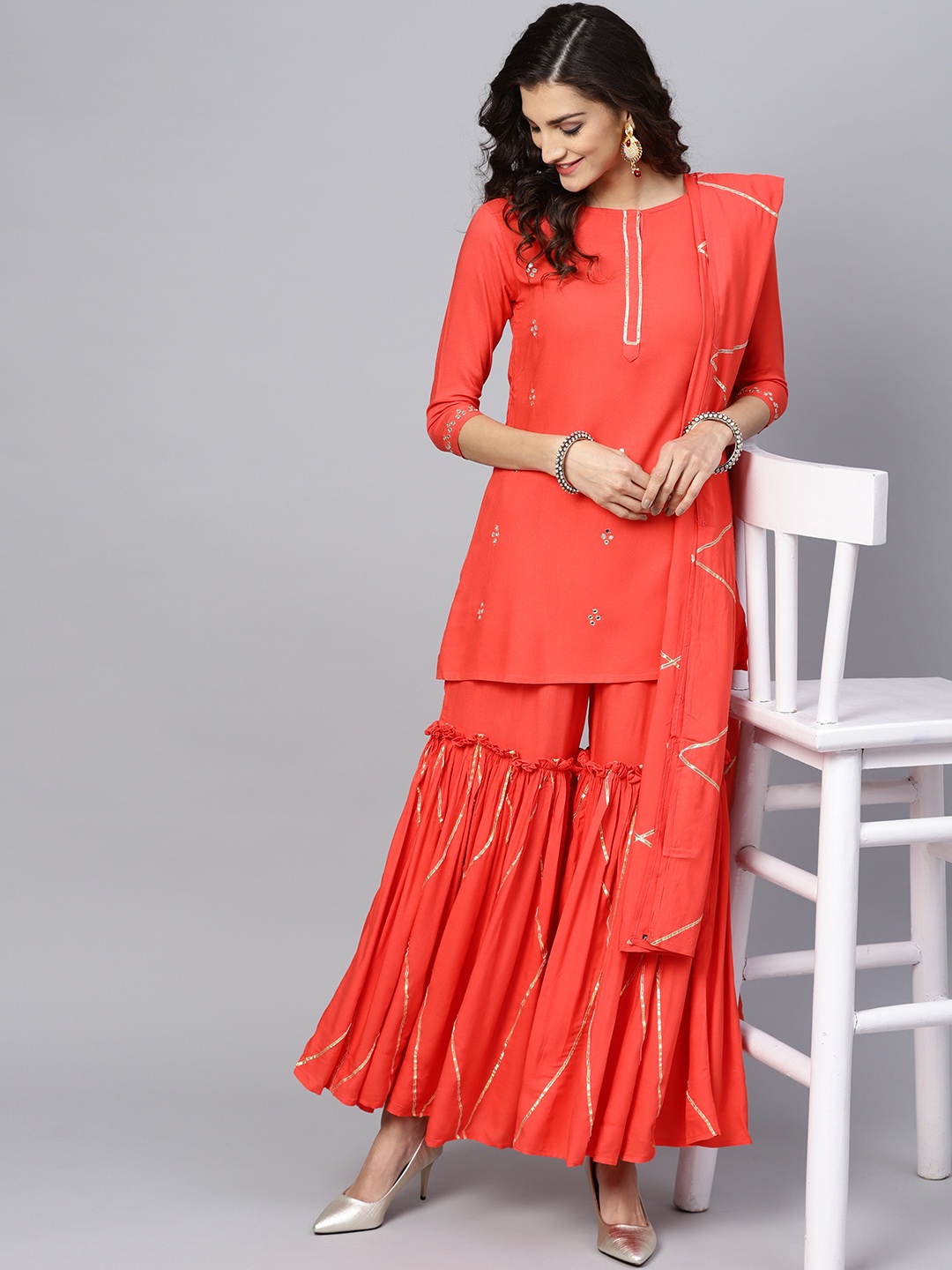 

Ishin Women Coral Red Solid Kurta with Sharara & Dupatta