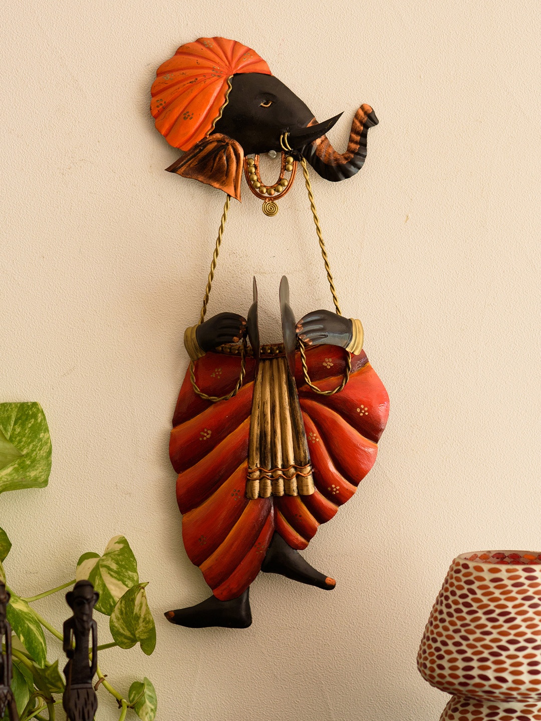 

eCraftIndia Orange & Black Ganesha Playing Manjeera Showpiece