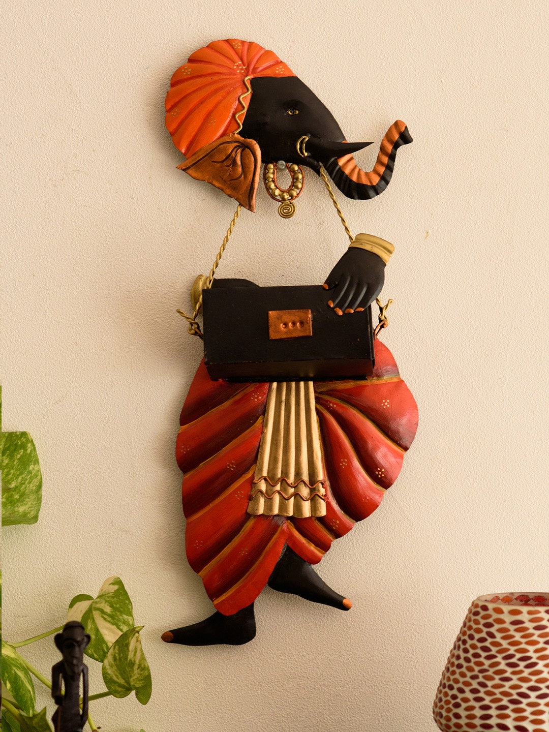 

eCraftIndia Orange & Black Ganesha Playing Harmonium Wall Hanging