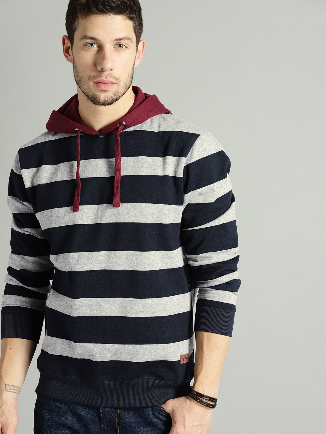 

The Roadster Lifestyle Co Men Grey Melange & Navy Blue Striped Hooded Sweatshirt