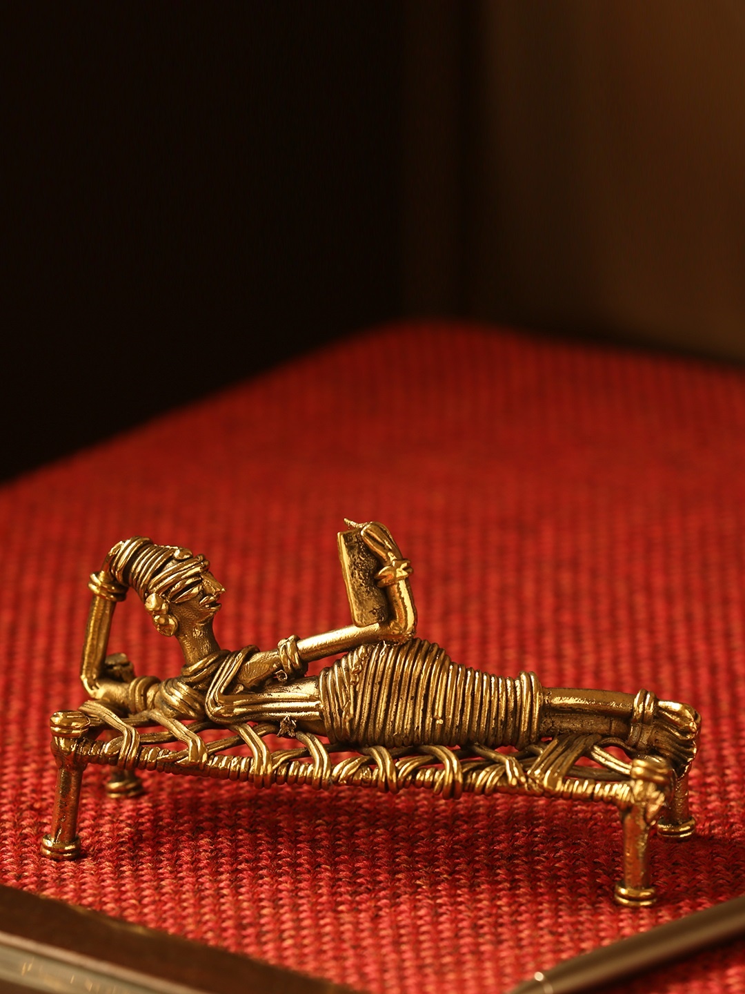 

ExclusiveLane Gold-Toned Reading Woman Handcrafted Dhokra Art Showpieces