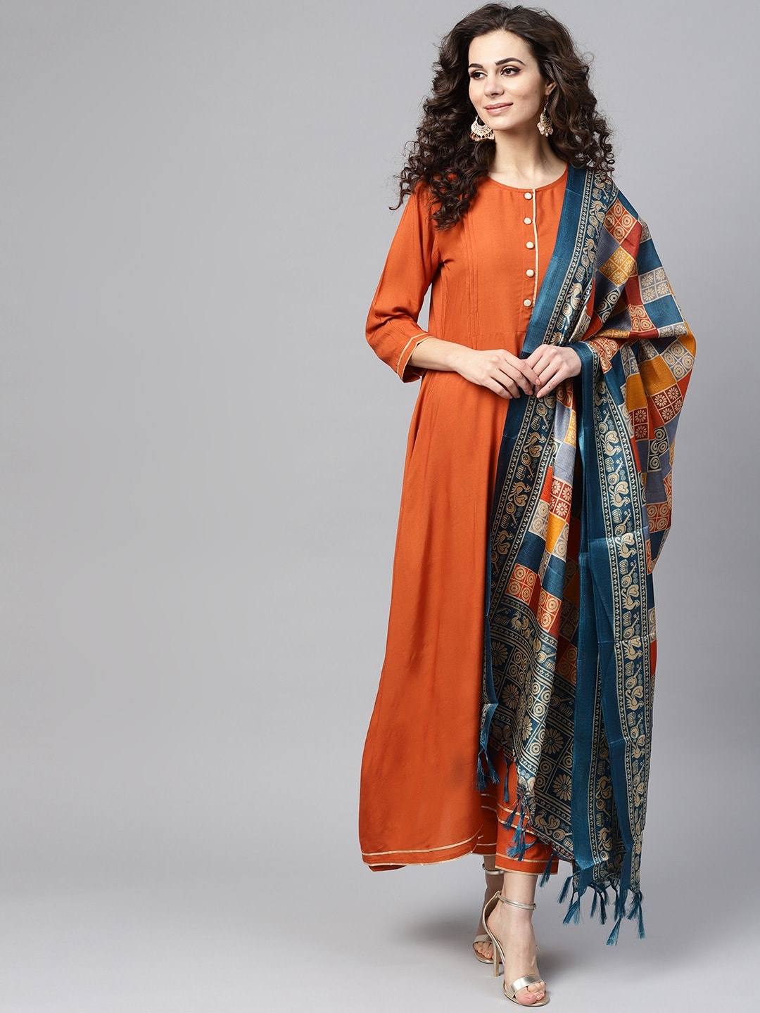 

Nayo Women Rust Orange & Teal Blue Solid Kurta with Trousers & Dupatta
