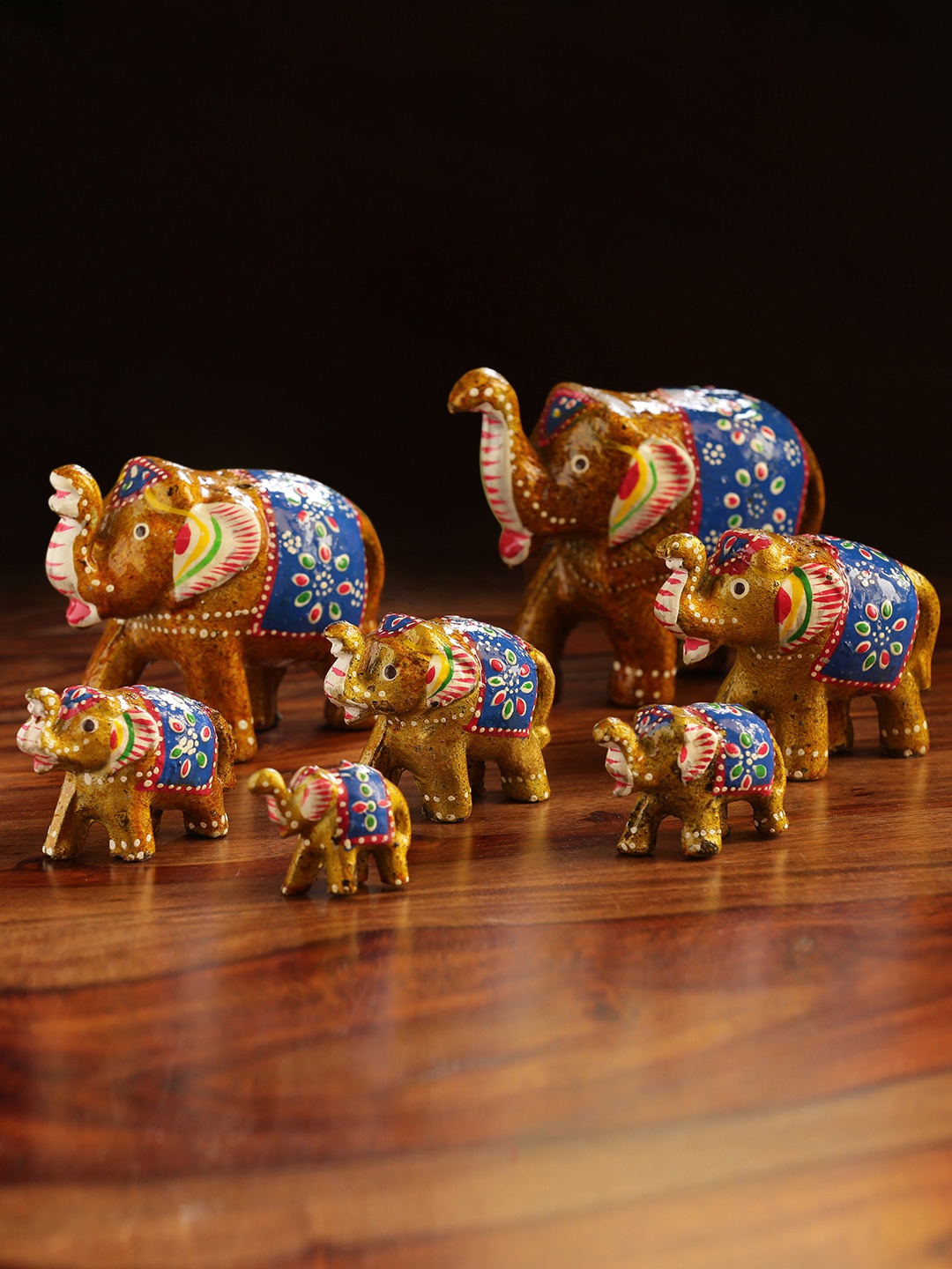 

ExclusiveLane Set of 7 Brown & Blue Handcarved Elephants Showpieces