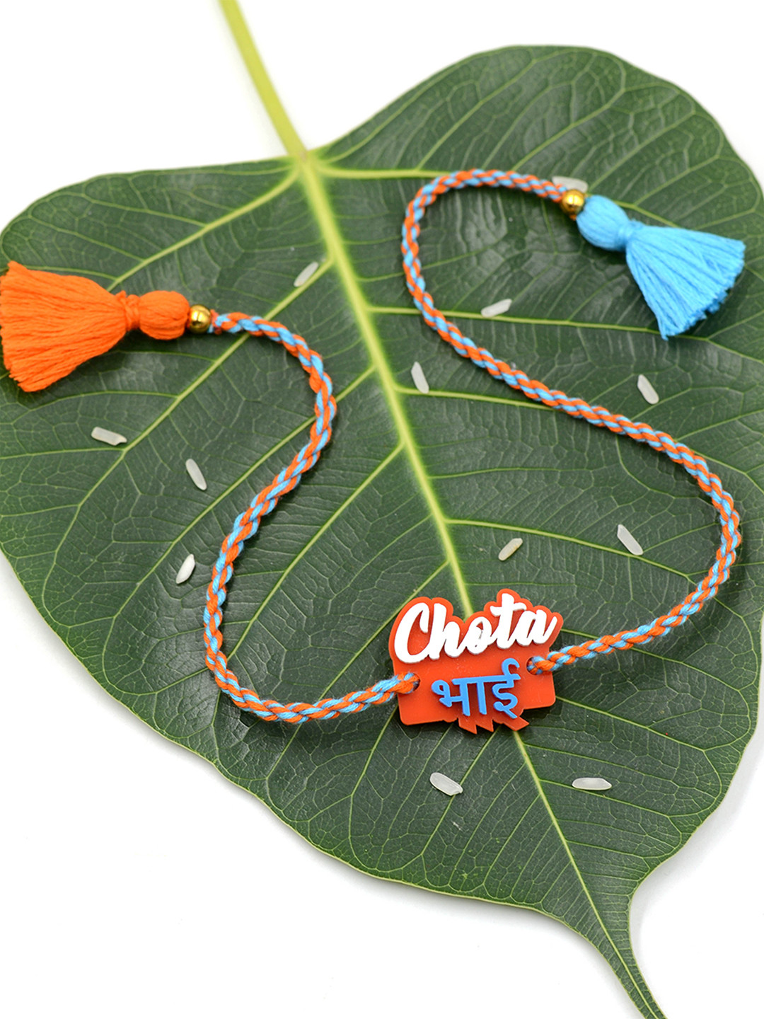 

Krafted With Happiness Orange & Turquoise Blue Plastic Rakhi