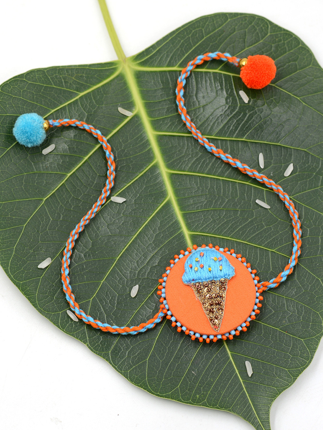 

Krafted With Happiness Orange & Blue Wraparound Softy Cone Rakhi