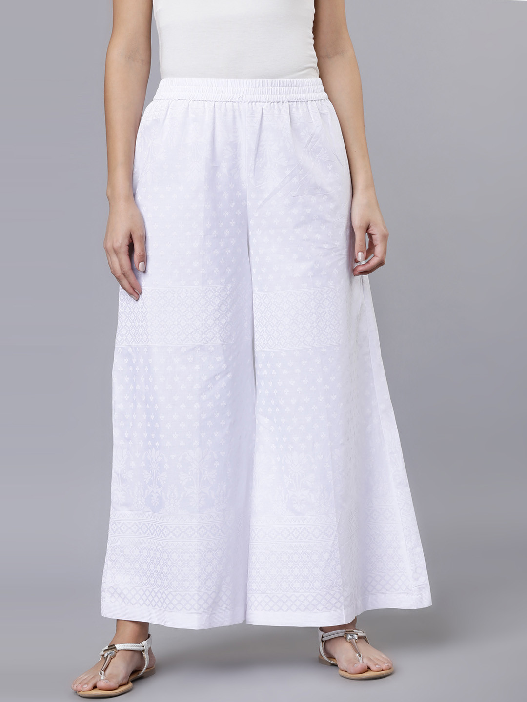 

Vishudh Women White Printed Flared Palazzos
