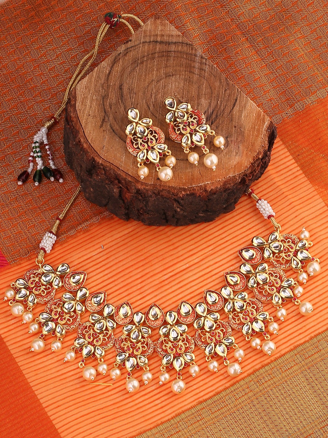 

Shoshaa Women Gold-Toned & Red Handcrafted Enamelled Kundan Jewellery Set