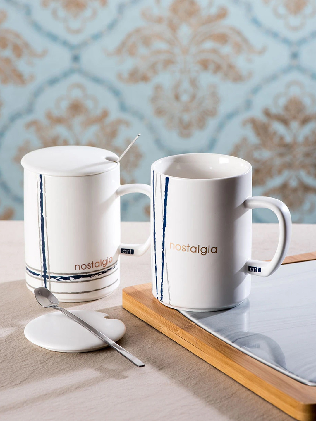 

THEDECORKART Set of 2 White Printed Ceramic Coffee Mugs With Lids & Spoons