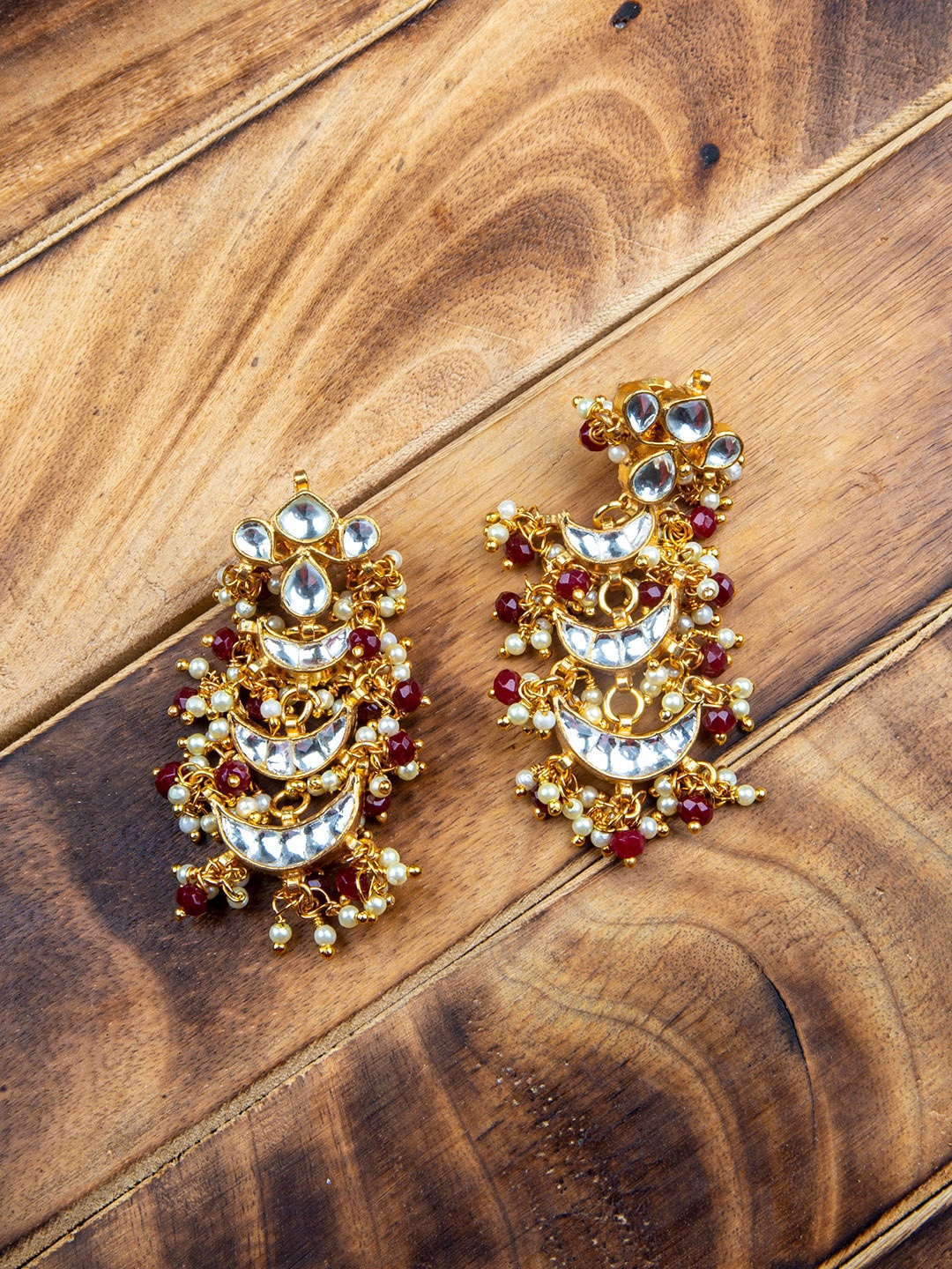 

MORKANTH JEWELLERY Gold-Plated & Maroon Ruby Studded Crescent Shaped Chandbalis