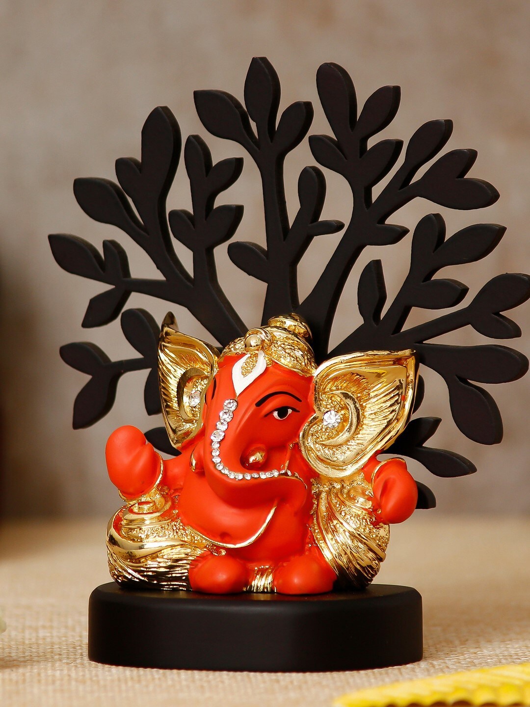 

eCraftIndia Orange & Gold-Toned Kaan Ganesha With Wooden Tree Show Piece