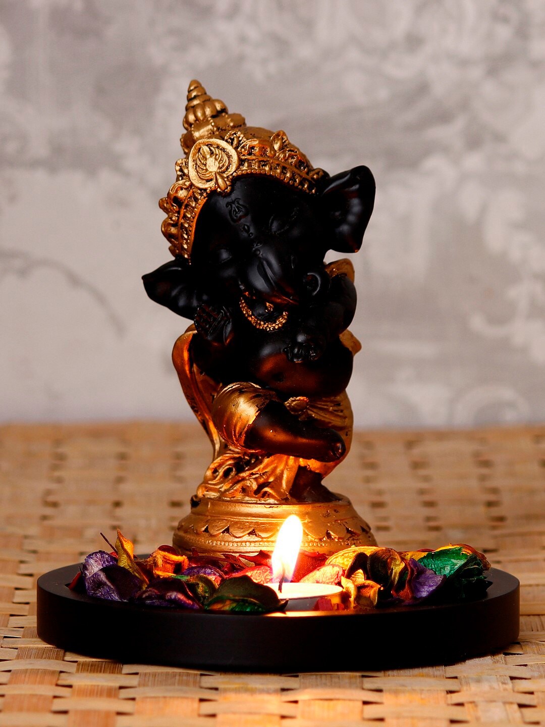 

eCraftIndia Gold-Toned & Black Textured Wooden Handcrafted Lord Ganesha Dancing Avatar Showpiece with Fragranced Petals & Tealight