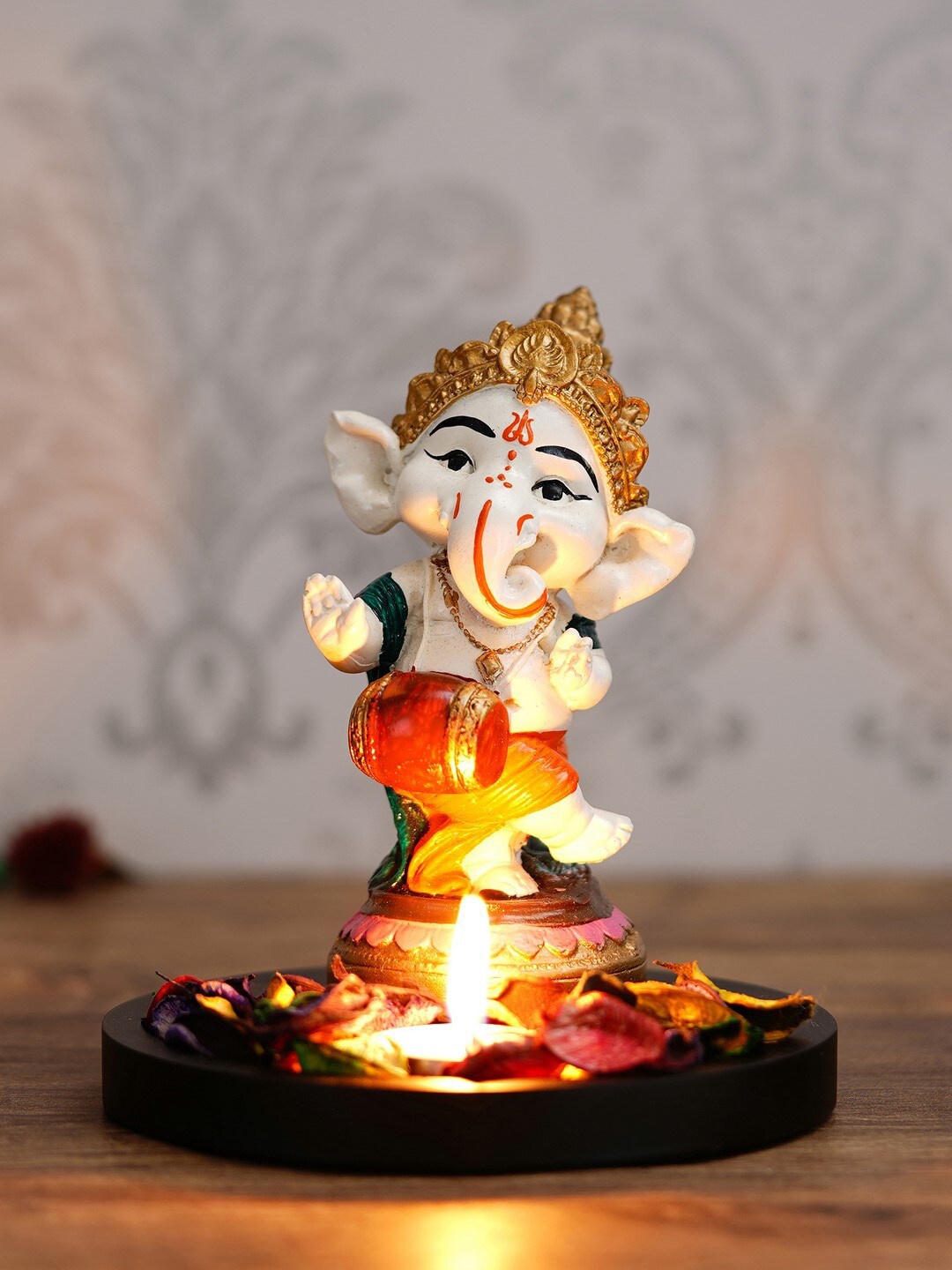 

eCraftIndia White & Orange Handcrafted Lord Ganesha Dancing Avatar with Wooden Base, Petals and Tealight Decorative Showpiece