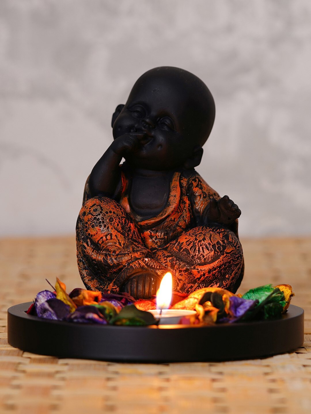 

eCraftIndia Brown & Black Decorative Smiling Monk Buddha With Wooden Base Fragranced Petals & Tealight Showpiece