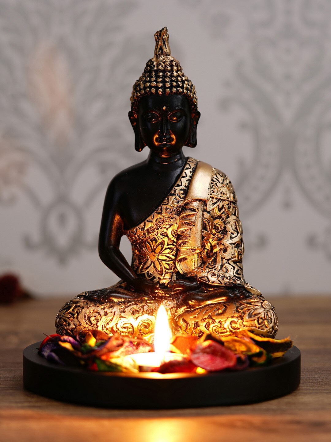 

eCraftIndia Gold-Toned & Black Textured Wooden Handcrafted Meditating Lord Buddha Idol Showpiece with Fragranced Petals & Tealight