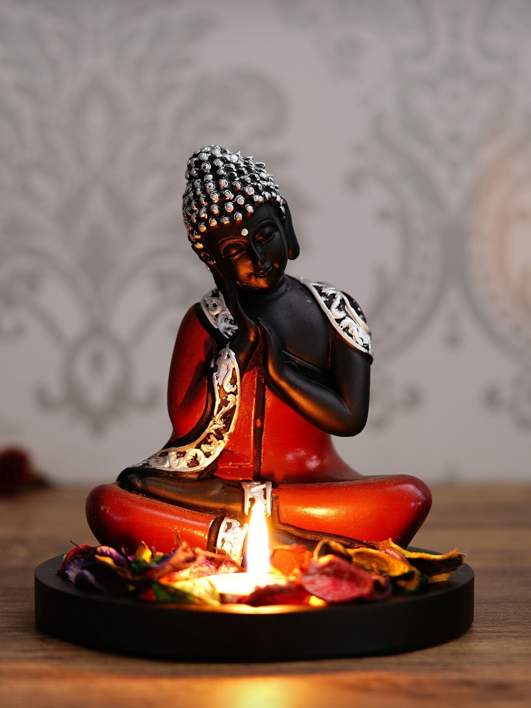 

eCraftIndia Red & Black Antique Finish Handcrafted Thinking Buddha With Wooden Base Petals & Tealight
