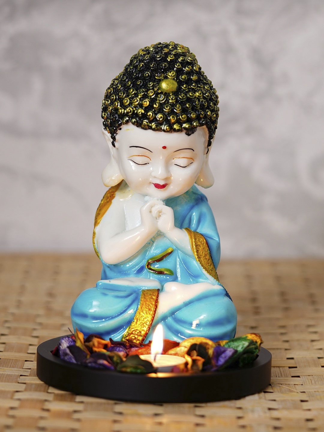 

eCraftIndia Blue & Beige Praying Monk Buddha With Wooden Base Fragranced Petals & Tealight