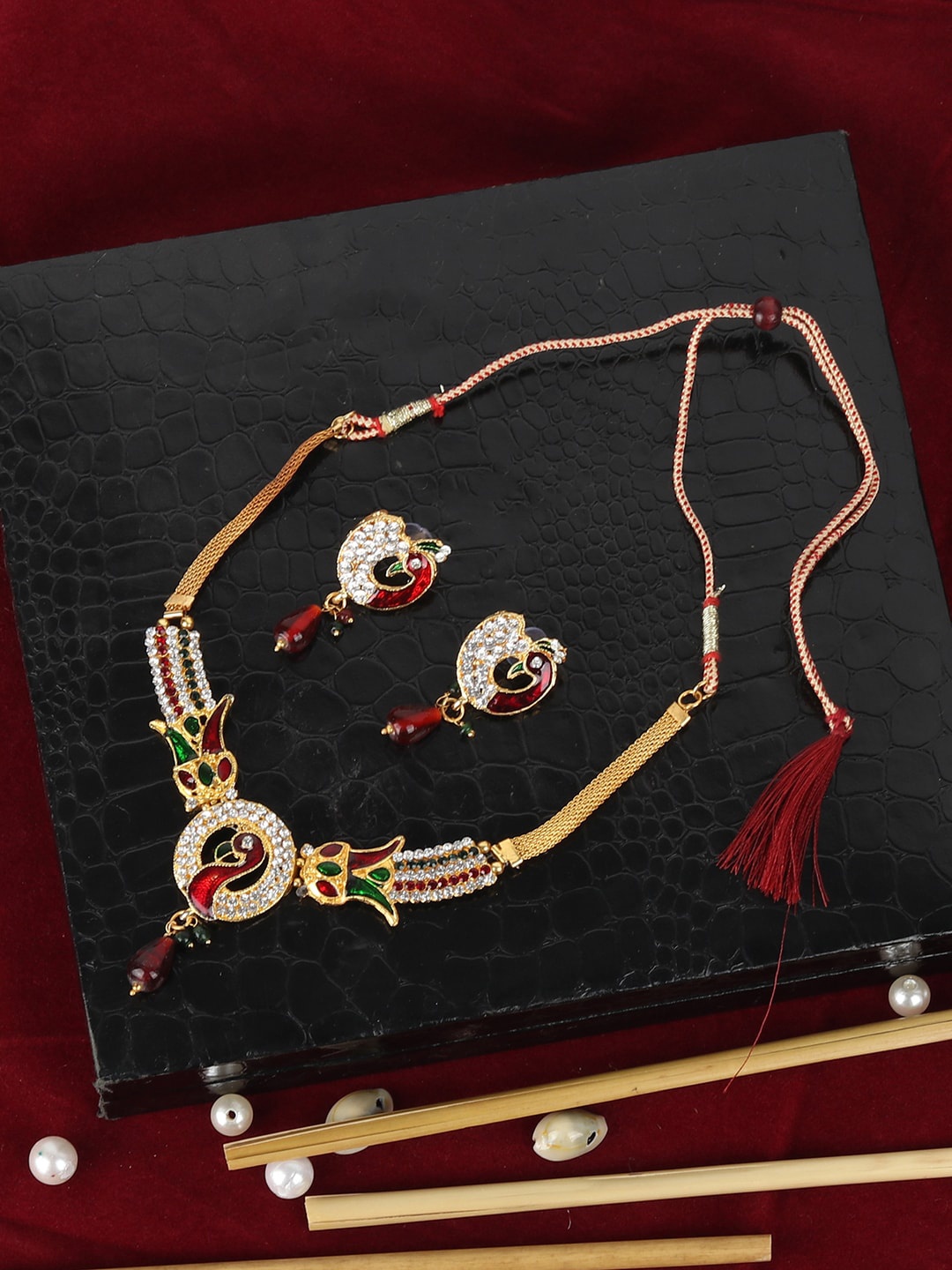 

ANIKAS CREATION Gold-Plated Red & Green Stone-Studded Peacock-Shaped Handcrafted Jewellery Set