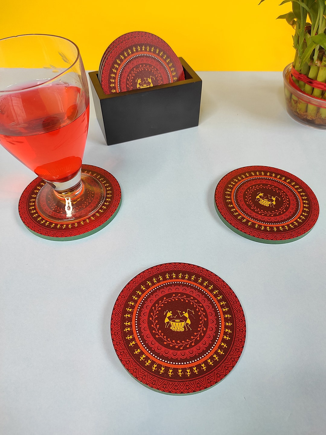 

CRAYTON Set Of 6 Maroon & Red Warli Print Round Wooden Coasters With Holder