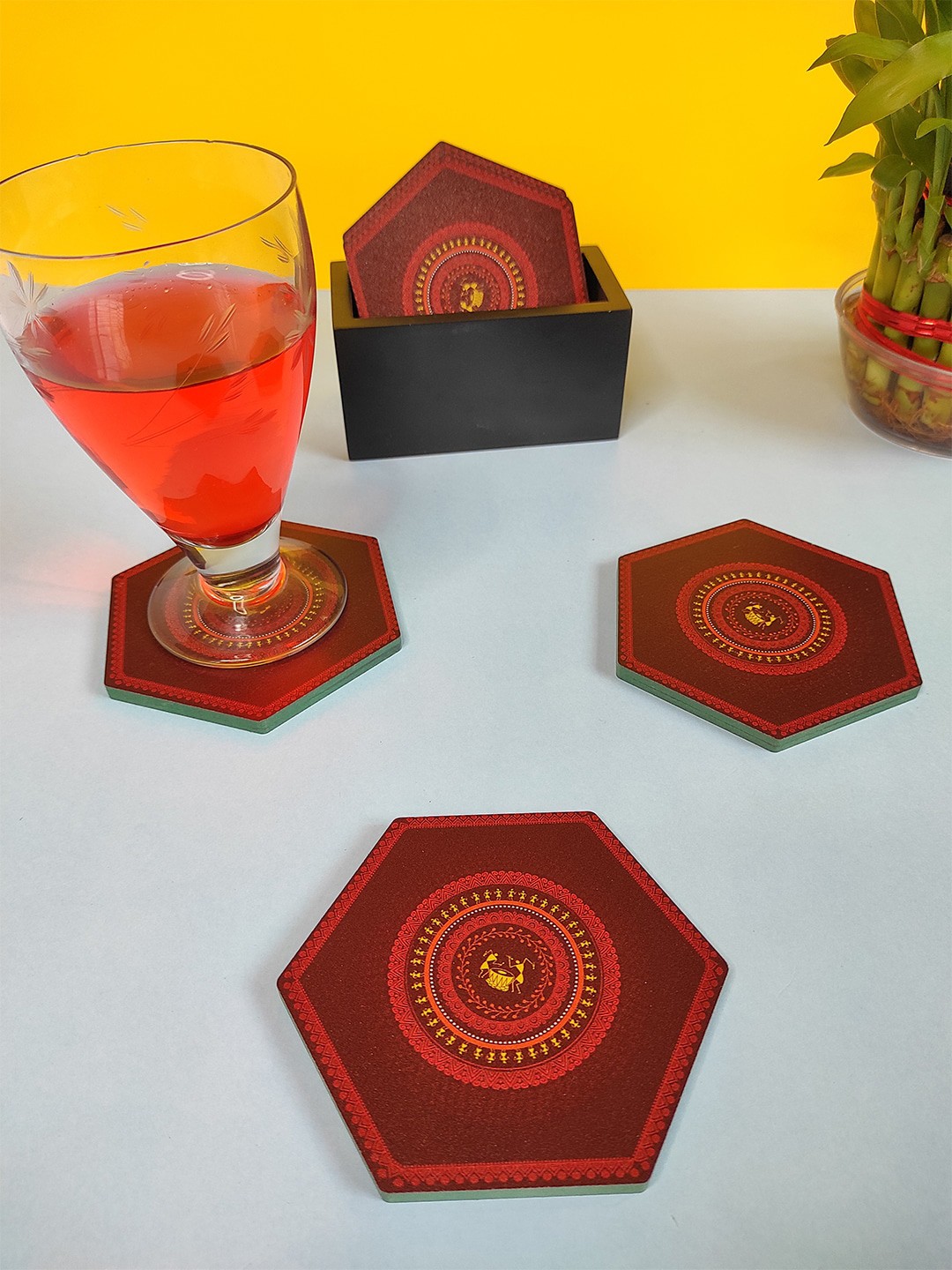 

CRAYTON Set Of 6 Maroon & Red Warli Print Hexagon Wooden Coasters With Holder