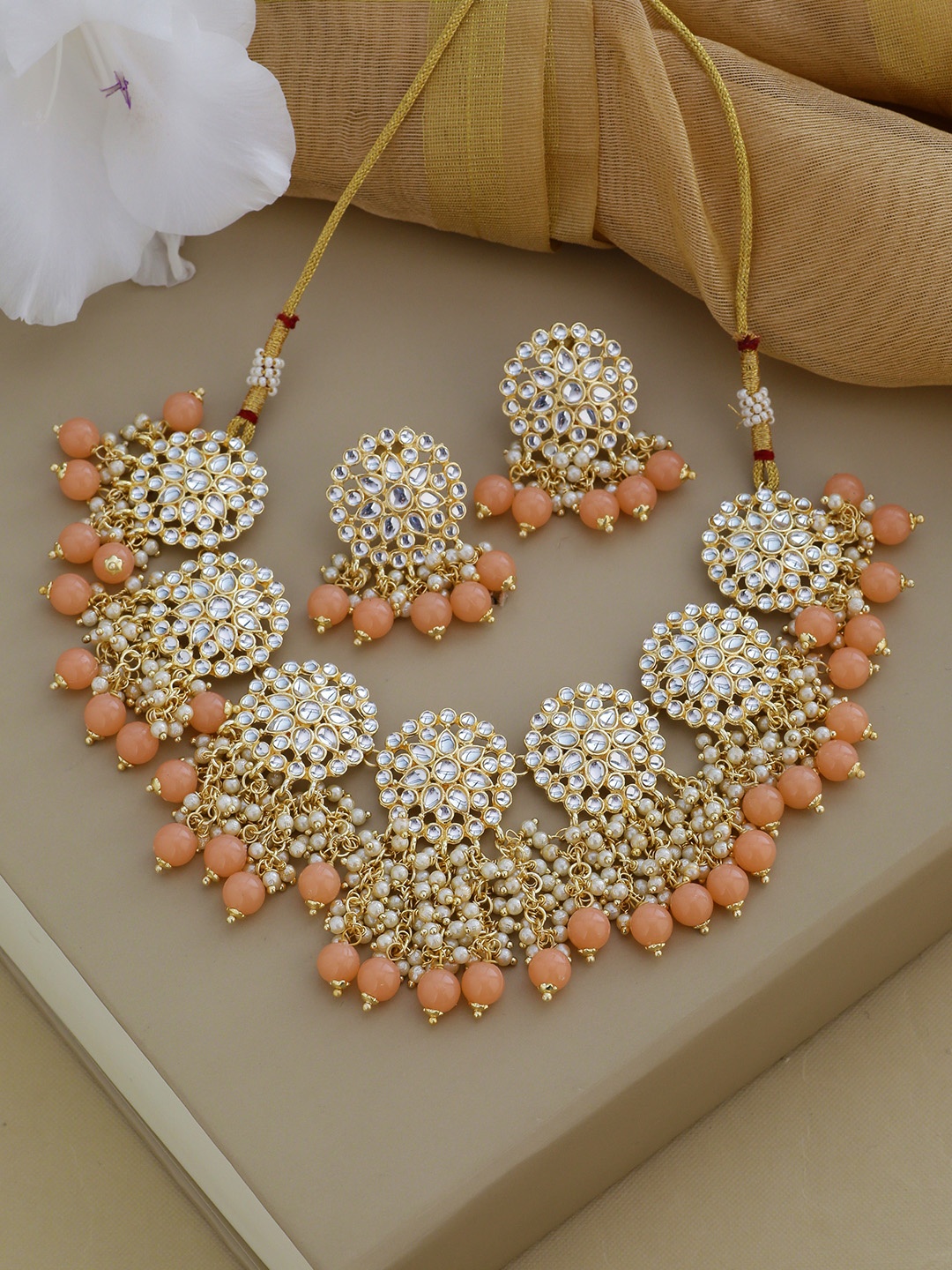 

Shoshaa Gold-Plated White Kundan-Studded & Peach-Coloured Beaded Jewellery Set
