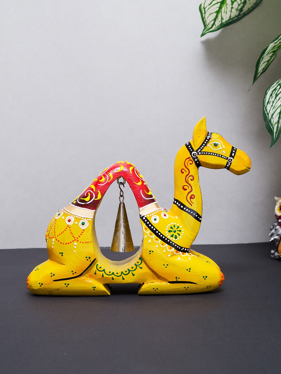 

Golden Peacock Yellow Handmade Wooden Camel with Iron Bell Showpiece