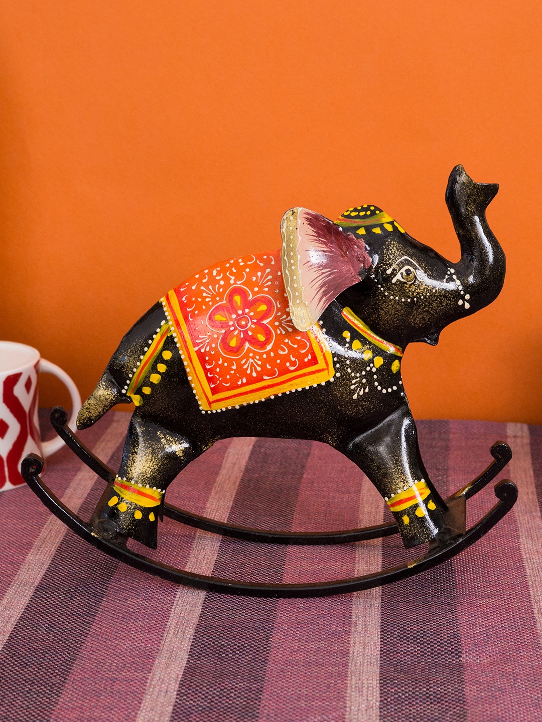

Golden Peacock Black & Orange Handcrafted Metal Rocking Elephant Showpiece