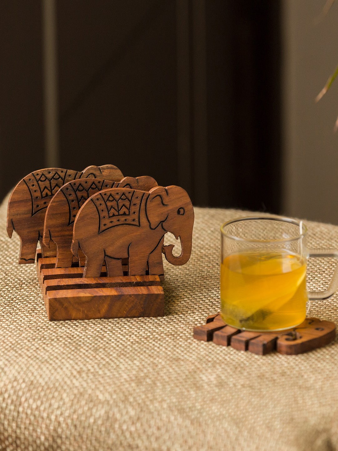 

ExclusiveLane Set Of 4 Handcrafted The Elephant Warriors Sheesham Wood Coasters With Stand, Brown